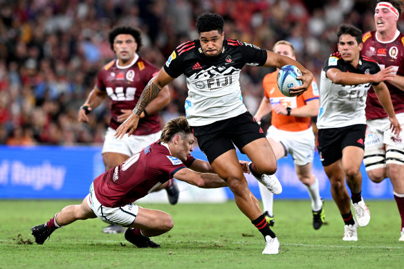 Leicester Fainga’anuku of the Crusaders breaks away from the defence at Suncorp Stadium.