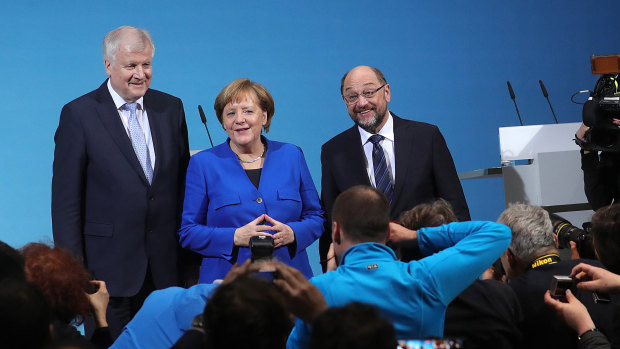 Horst Seehofer of the Christian Social Union, German Chancellor Angela Merkel and Martin Schulz of the Social Democrat Party reached a coalition deal after marathon negotiations. 