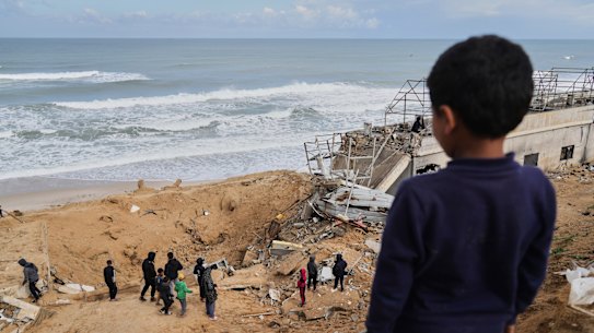 Palestinians inspect the rubble.
