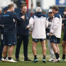 Brad Davis (left, with earpiece) is pictured in a Wallabies coaching huddle in Melbourne.