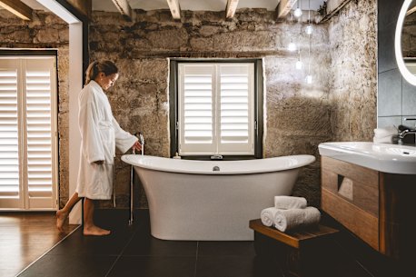 Relax and unwind in the beautifully appointed bathroom at Trianna Barracks, where historic charm meets modern comfort.