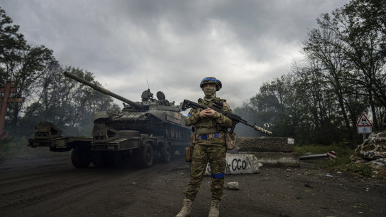 A Ukrainian serviceman stands at the checkpoint near the recently retaken area of Izium.