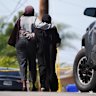 Two women embrace near the scene of the San Diego shooting.