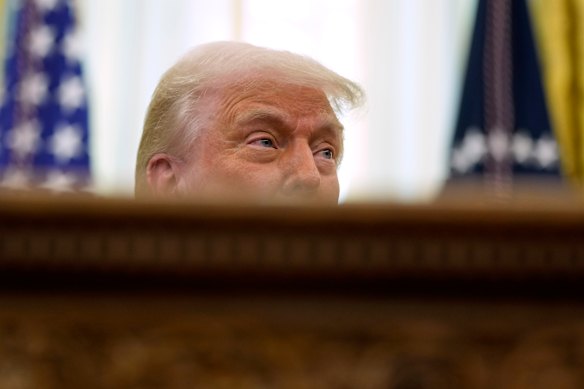 President Donald Trump speaks to reporters after signing an executive order in the Oval Office of the White House.