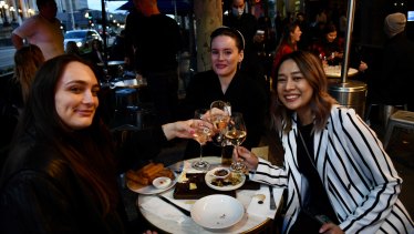 Libby Pratt (left), Emily Greenwood (middle) and Tuu Chandang enjoying post-work drinks on Spring Street. 