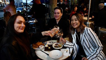 Libby Pratt (left), Emily Greenwood (middle) and Tuu Chandang enjoying post-work drinks on Spring Street. 