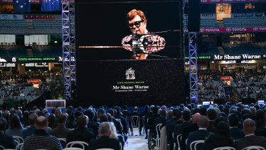A recorded musical performance by Sir Elton John is shown on the MCG scoreboards.