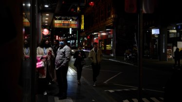 Customers lining up outside of a restaurant in Chinatown on Friday night. 