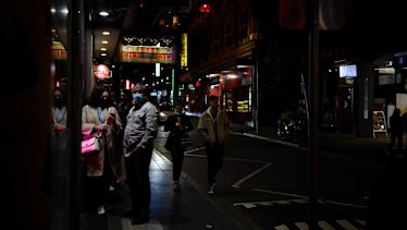 Customers lining up outside of a restaurant in Chinatown on Friday night. 