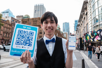 Nakamura with his new QR code, which other Sydney buskers said was a must-have.
