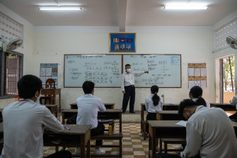 Students attend a socially distanced class at a high school in Phnom Penh as schools began re-opening in Cambodia last month.