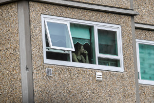 A resident stuck in their flat at a locked down tower in Flemington.