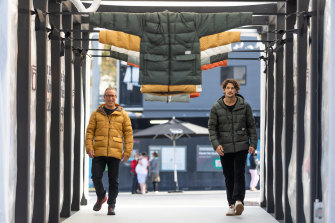 Kathmandu chief executive Reuben Casey with Jarrod Scott, wearing the BioDown biodegradable puffer jacker in a pop-up installation by Joost Baker made using clothing destined for landfill.