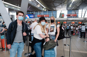 Julian Seesink, Muriël De Kroon and Iina Mäkelä queue at Sydney Airport on Tuesday.