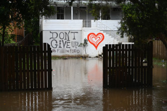 Floodwaters reach a house in Lismore on Tuesday morning.