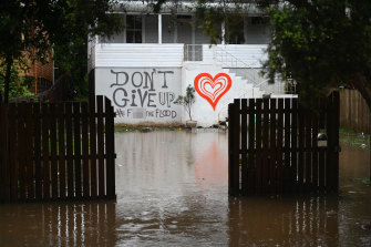 Floodwater approaches a house in Lismore on Tuesday morning.