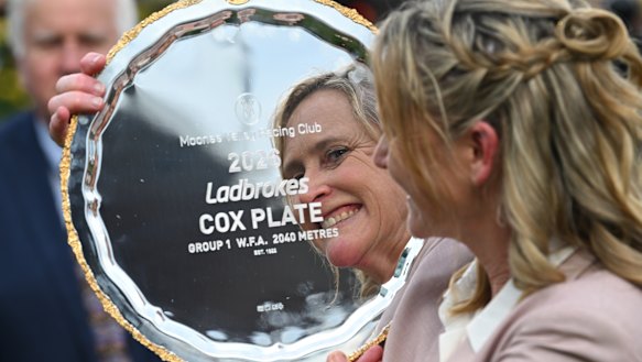 Trainer Andrea Leek poses with the trophy.