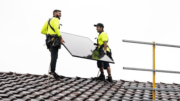 Solar panels being installed on the rooftop of an Australian home.