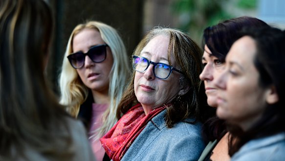 Samantha Knight's mother Tess Knight , centre, speaks outside court on Monday.