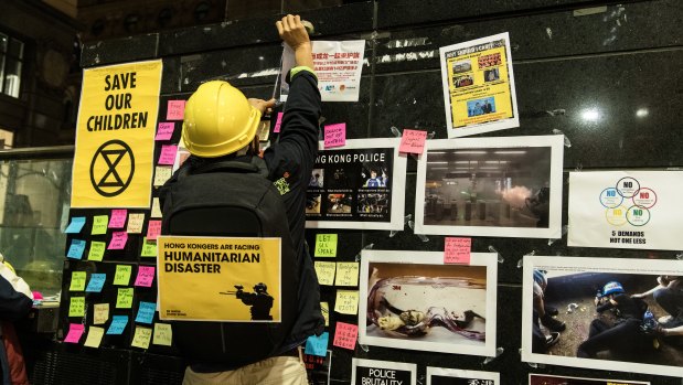 Protesters declared their support for Hong Kong on a Lennon wall on the back of the Martin Place fountain. 