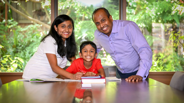 Year 4 student Aveen and parents Layanga (left) and Thepul Seekkuge at home.