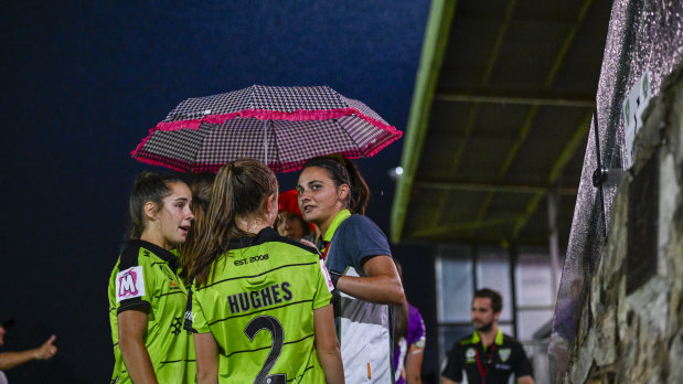 Canberra United players after the match was called off due to storms.