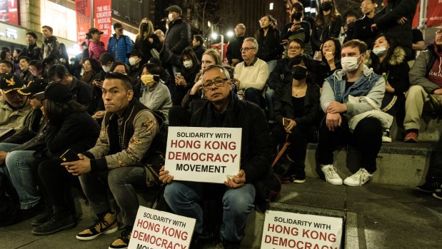 Protesters hold pro-Hong Kong signs at the "Stand With Hong Kong" rally at Martin Place on Friday night.