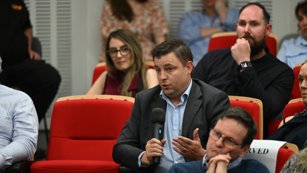 An audience member questions the panel.