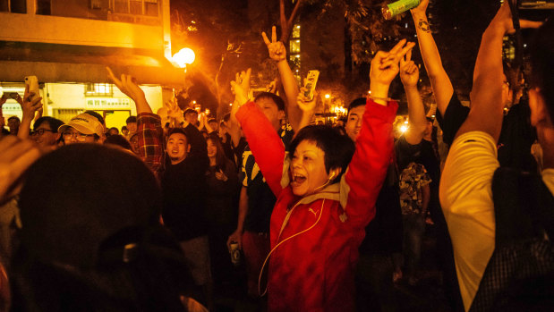 Residents celebrate as pro-Beijing candidate Junius Ho loses in the district council elections.