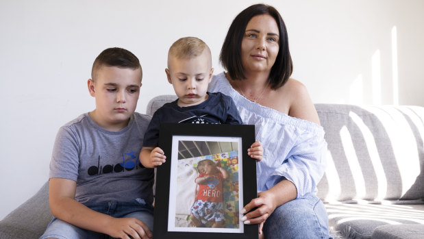 Elizabeth Miroforidis with her sons Romeo and Alex Kakias with a photo of her late brother Elias.