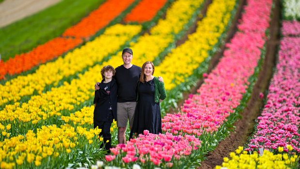 Tulip farmers Paul Tesselaar and wife Rachael on the farm with their son Austin.