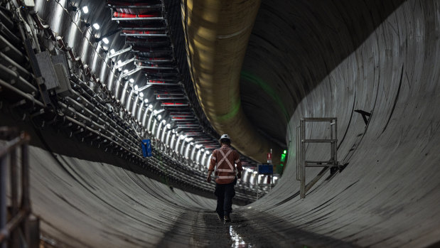A worker walks through one of the twin tunnels being constructed under Rosehill Racecourse near Parramatta.