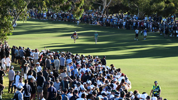Cameron Smith walks down the 18th fairway in front of massive crowds at Grange Golf Club.
