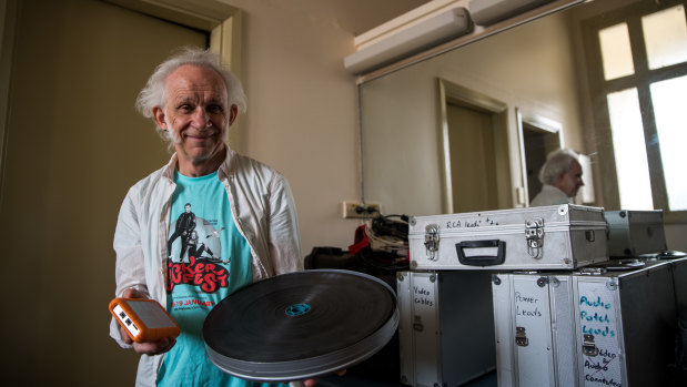 Celluloid versus digital: projectionist Alan Butterfield with a multi-movie hard-drive and a 20-minute film reel. 