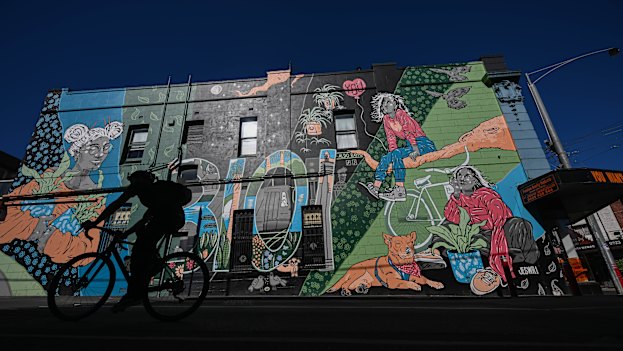 Cycling past a mural in Brougham Street.