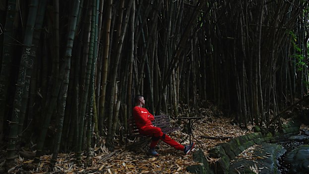 A resident of We Help Ourselves soaks in the tranquillity of the bamboo forest in Callan Park.
