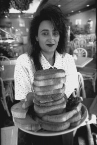 Zoey Volkanovska with a stack of sizzler cheese toasts. May 20, 1994. 