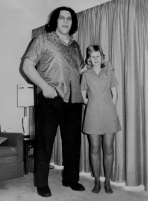 Wrestler Andre the Giant, 7ft 5in tall, stands next to hotel employee Wendy Owsinski, 19, 5ft 9 in tall.