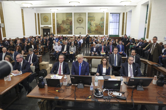 Former president Donald Trump, centre, appears in court in New York on October 2.