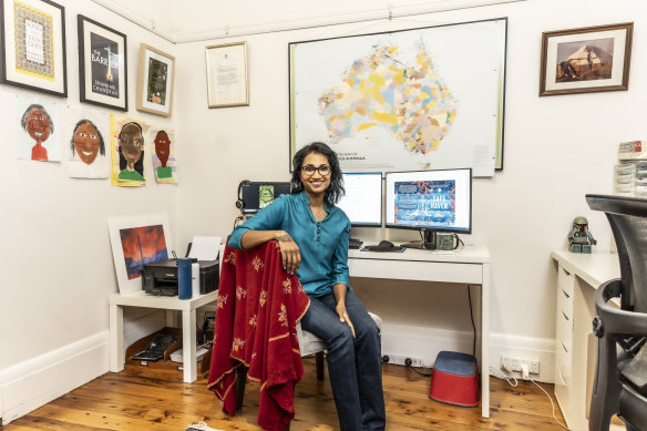 Chandran in her office, backdropped by a map of Indigenous Australia and artwork by her children.