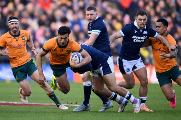 Joseph-Aukuso Suaalii attacks the Scottish line.
