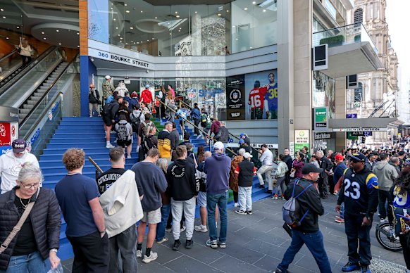 Fans queue for merchandise at the NFL shop in the CBD. 