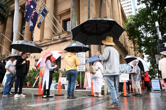 People wait to cast their votes at the Brisbane City Hall polling centre.