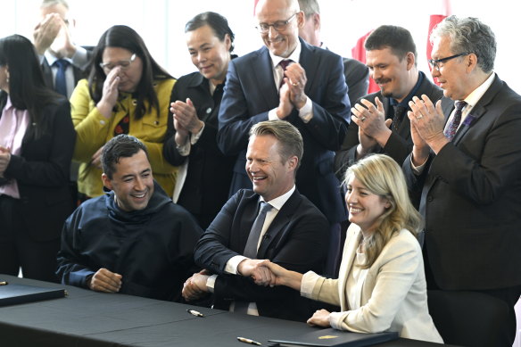 Greenland Prime Minister Mute Bourup Egede, left, Denmark’s Minister for Foreign Affairs Jeppe Kofod, center, and Canada’s Minister of Foreign Affairs Melanie Joly share a three-way handshake after signing an agreement that will establish a land border between Canada and Denmark on Hans Island.