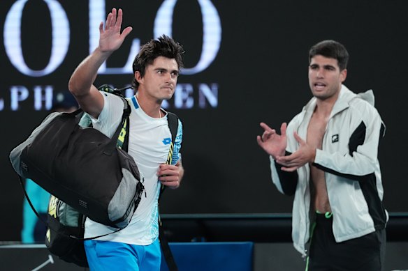 Adam Walton, left, of Australia waves as he leaves the court on Sunday night.