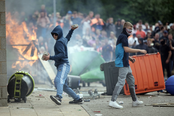 Anti-migration protesters riot outside the Holiday Inn Express in Manvers, which is being used as an asylum hotel.