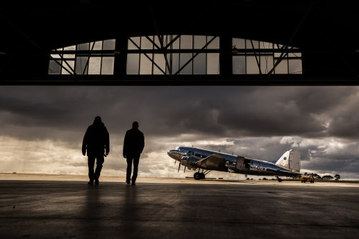 A 40-year success: Father and son at Shortstop Jet Charter’s Essendon Fields Airport hangar with their vintage DC-3 airliner.