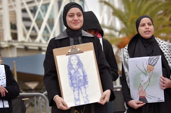 Wesam Hamada, the mother of Hind Rajab, holds a drawing of her daughter by the artist Mar Gregorio, during a memorial and protest in Barcelona marking the second anniversary of her daughter’s killing by Israeli forces in Gaza.