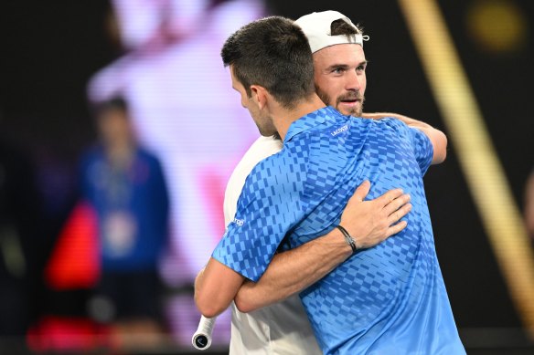 Novak Djokovic hugs Tommy Paul after their semi-final.