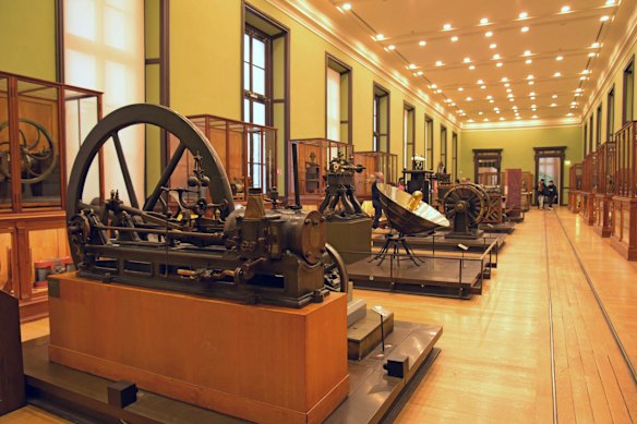 Vintage steam engine and other machinery on display in the Musee des Arts et Metiers.